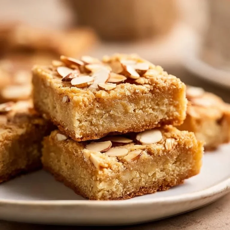 Delicious Vegan Almond Cookie Bars on a wooden table with almonds